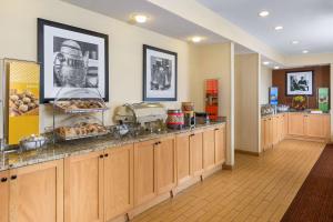 a cafeteria with a counter with food on it at Hampton Inn Zanesville in Zanesville