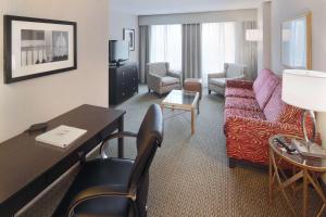 a living room with a couch and a table in a hotel room at Hampton Inn & Suites Arlington Crystal City DCA in Arlington