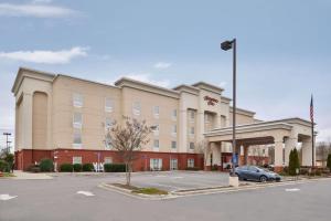 a hotel with a car parked in a parking lot at Hampton Inn Statesville in Statesville