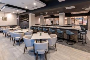 a restaurant with tables and chairs and a bar at DoubleTree by Hilton Denver Cherry Creek, CO in Denver