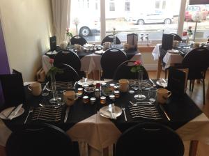 a group of tables in a room with chairs and tablesearcher at The Dragonfly in Blackpool