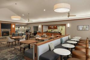 a restaurant with tables and chairs and a bar at Homewood Suites by Hilton Allentown-Bethlehem Airport in Bethlehem