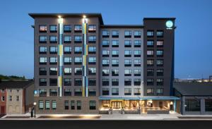 a large building with a clock on top of it at Tru By Hilton Baltimore Harbor East in Baltimore