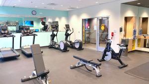 a gym with several treadmills and exercise bikes at Tru By Hilton Baltimore Harbor East in Baltimore