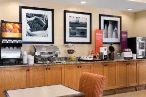 a kitchen with a counter with a coffee maker at Hampton Inn Houston Willowbrook Mall in Houston