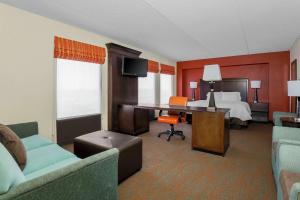 a hotel room with a bed and a desk at Hampton Inn Chicago-Midway Airport in Chicago