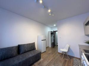 a living room with a couch and a kitchen at Best for 2 in Pabianice