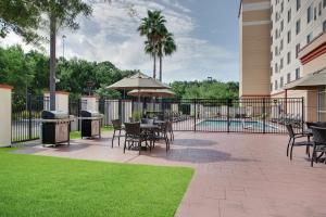 a patio with tables and chairs and a pool at Homewood Suites by Hilton Tampa-Brandon in Tampa