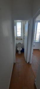 a bathroom with a toilet and two windows at GHIS Lotus in Cannes