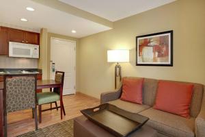 a living room with a couch and a kitchen at Homewood Suites by Hilton Tampa-Brandon in Tampa