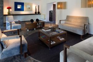 a living room with two chairs and a coffee table at Hotel Boutique Ses Pitreras in San Antonio Bay
