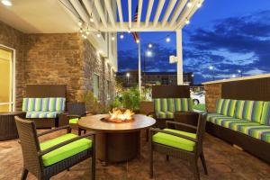 a patio with a table and chairs and a fire pit at Home2 Suites by Hilton San Angelo in San Angelo