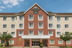 a large red brick building with a sign on it at Homewood Suites by Hilton Allentown-West/Fogelsville in Fogelsville