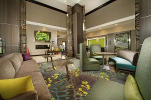 a lobby with a couch and chairs and tables at Hilton Garden Inn College Station in College Station