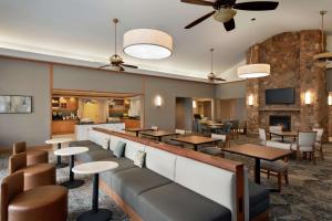 a restaurant with tables and chairs and a fireplace at Homewood Suites by Hilton Allentown-West/Fogelsville in Fogelsville