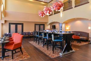 a dining room with a long table and chairs at Hampton Inn & Suites Albuquerque-Coors Road in Albuquerque