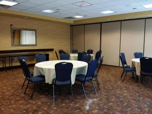 a conference room with tables and chairs and a podium at Hampton Inn & Suites - Coors Road in Albuquerque +21 photos