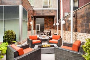 an outdoor patio with chairs and a fire pit at Hilton Garden Inn West 35th Street in New York