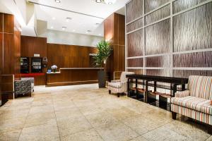 a lobby with two chairs and a waiting room at Hilton Garden Inn West 35th Street in New York