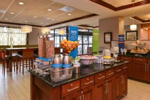 a kitchen with a counter with food on it at Hampton Inn College Park in College Park