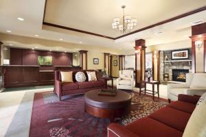 a living room filled with furniture and a chandelier at Homewood Suites Atlantic City Egg Harbor Township in Egg Harbor Township