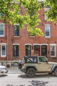 a jeep parked in front of a brick building at Beautiful & Stylish 2 BDR Hosted By StayRafa (1F) in Philadelphia