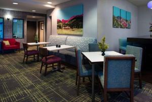a restaurant with tables and chairs and a couch at Hampton Inn Glenwood Springs in Glenwood Springs