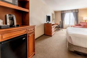 ein Hotelzimmer mit einem Bett und einem TV in der Unterkunft Hilton Garden Inn Houston/The Woodlands in The Woodlands