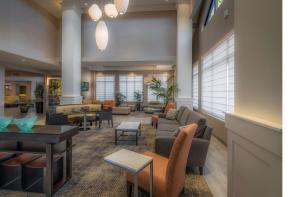 a lobby with a waiting area with couches and chairs at Hilton Garden Inn Reagan National Airport in Arlington