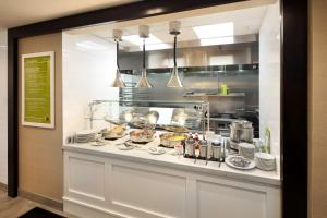 a kitchen with a counter with food on it at Hilton Garden Inn Reagan National Airport in Arlington