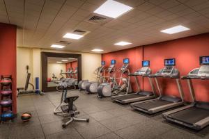 a gym with several treadmills and machines in a room at Hilton Garden Inn Reagan National Airport in Arlington