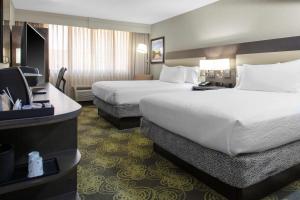 a hotel room with two beds and a television at Hilton Garden Inn Reagan National Airport in Arlington