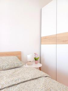 a bedroom with two beds and a table with a lamp at Apartma AJDA in Velenje