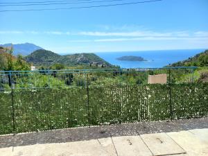 a fence with a view of the ocean at Apartmani Vujovic Markovici in Budva