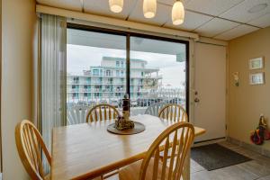 a dining room with a table and a large window at Cozy Oceanfront Condo with Pool and Beach Access! in Wildwood Crest