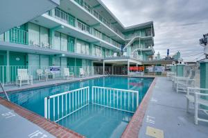 a swimming pool in front of a building at Cozy Oceanfront Condo with Pool and Beach Access! in Wildwood Crest