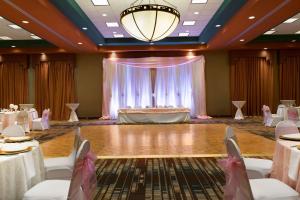 a ballroom with a dance floor and a table with chairs at Embassy Suites by Hilton Albuquerque in Albuquerque