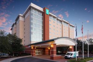 a hotel with a car parked in front of it at Embassy Suites North Charleston Airport Hotel Convention in Charleston