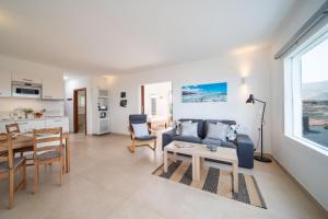 a living room with a couch and a table at Vaya Querida in Mala