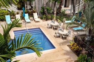 a swimming pool with chairs and tables in a courtyard at KBM Resorts Grand Champions GCH 42 NEW Remodeled 2 Bedrooms Villa in Heart of Wailea Includes Rental Car in Wailea