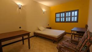 1 dormitorio con 1 cama, 1 mesa y 1 silla en AR Sun Hotel, en Antsiranana