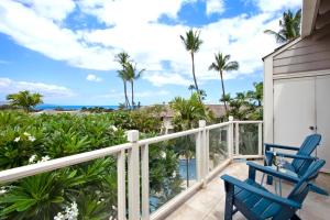 a balcony with two blue chairs and the ocean at KBM Resorts Grand Champions GCH 42 NEW Remodeled 2 Bedrooms Villa in Heart of Wailea Includes Rental Car in Wailea