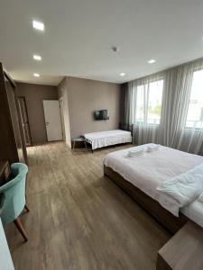 a large bedroom with two beds and a window at Hotel FLEUR DE LIS in Gonio