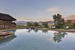 a large pool of water with two chairs in it at Montusi Mountain Lodge in Bonjaneni