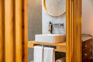 a bathroom with a white sink and a mirror at Casa Da Avo Clementina Nº32 in Funchal