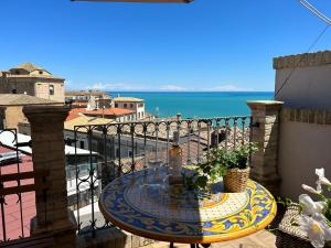 a table on a balcony with a view of the ocean at La Fabbrica di San Pietro Vasto in Vasto