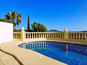 a swimming pool in front of a fence at Villa Panorama in Jávea