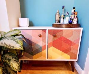 a dresser with alcohol bottles on top of it at Sunny Victorian with Stunning View and Wraparound Deck in San Francisco