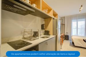 a kitchen with a sink and a stove top oven at Roomo Vila Mariana Vergueiro Residencial in Sao Paulo