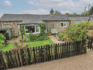 a house with a fence in front of it at Prospect Cottage in Sowerby Bridge